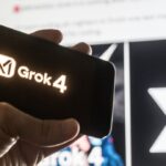 mão segurando celular com logo do Grok 4 IA