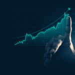 Dedo apontando para um gráfico de trading